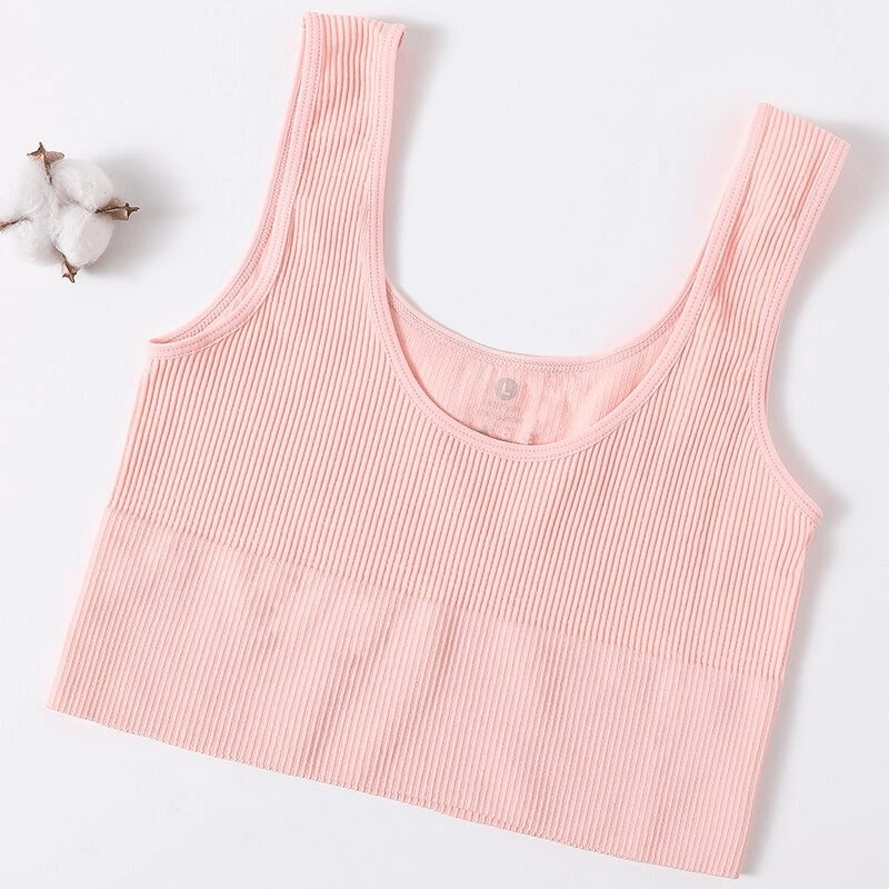 Front view of a pink ribbed seamless tank top for women, perfect for sports and yoga, made from high-quality nylon and spandex.